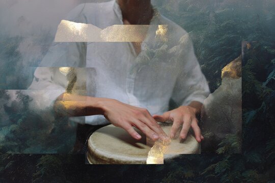 Mystic hands playing a hand drum layered over a forest scene with gold accents for atmospheric banner and background use