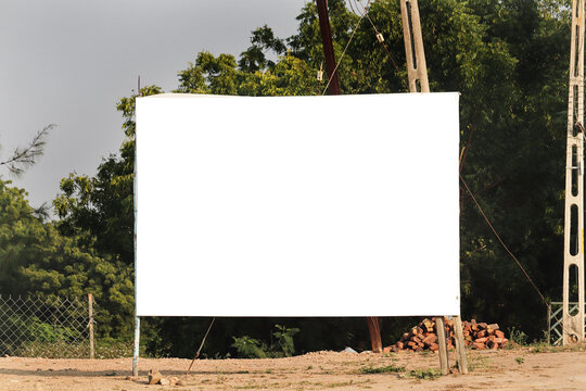 Blank Billboard Mockup Outdoors in Rural Area with Green Trees Background Large White Isolated Banner Template on Metal Frame and Dirt Ground, Empty Copy Space Signboard for Advertising