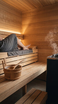 Modern Scandinavian style sauna interior close-up with natural wooden benches, ambient lighting and minimalist spa atmosphere