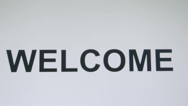 Welcome word typing on white computer screen animation for website introduction and business presentation footage.
