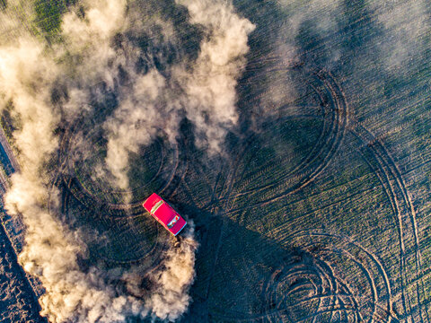 Red Lada Performing a Drift on a Dirt Field &ndash; Aerial Drone View