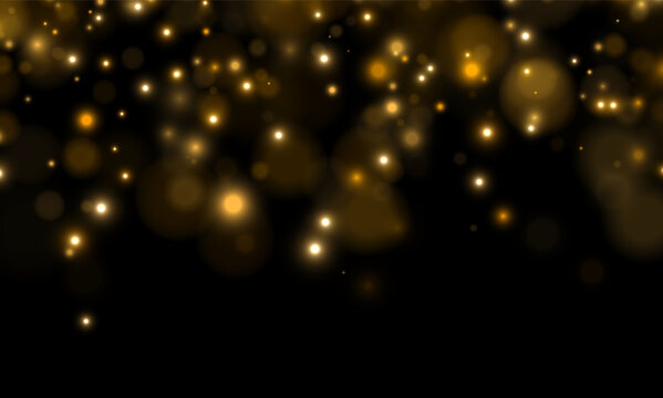 Soft glowing orbs scatter across a dark background creating a warm bokeh effect. The golden-yellow lights vary in size and intensity with gentle diffusion.