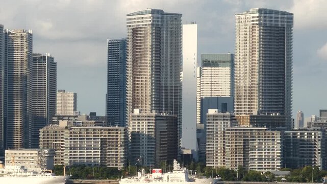Footage panning across a cluster of apartment buildings in Chuo Ward, Tokyo, from right to left.