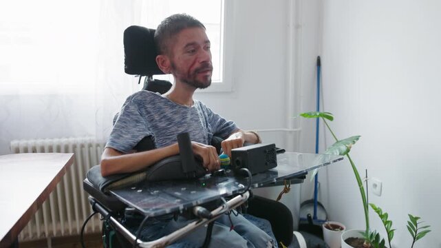 Man with disability getting ready with help from a Personal assistant , putting on glasses and a cap, daily personal assistance at home.