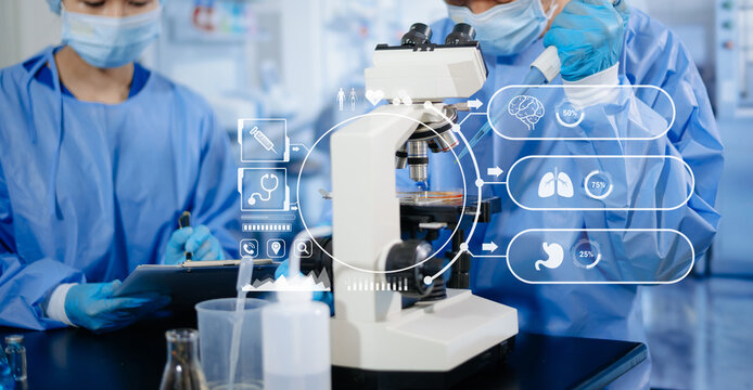 Medical researchers using pipettes, flasks, and advanced futuristic digital HUD graphics in laboratory research facility.