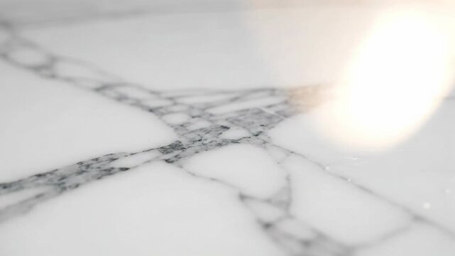 Luxurious white marble surface, natural stone material, featuring intricate grey veining and elegant texture. Abstract pattern showcasing sophisticated, serene surface, evoking calm, luxury