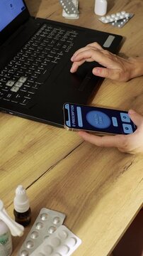 Female Patient Using Electronic Prescription on Smartphone and Laptop at Home. Vertical Footage