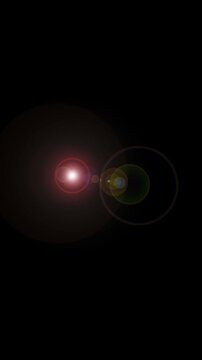 Optical lens flare moving across a dark background