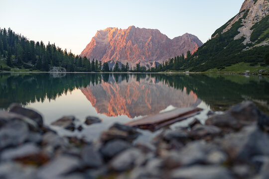 Reflecting Wetterstein Mountains in Warm Evening Light at Sunset. Seebensee, Austria