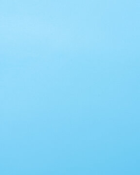 Clean light blue background with generous empty copy space. Minimal vertical backdrop for product presentation, advertising, branding, social media, text layouts and graphic design.