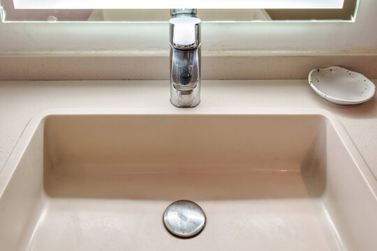 Modern bathroom sink and chrome faucet in contemporary hotel room interior