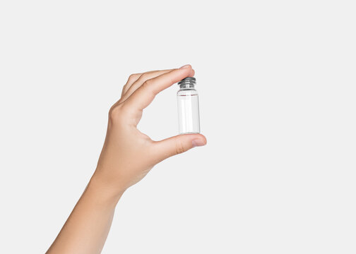 Hand Holding Small Glass Vial