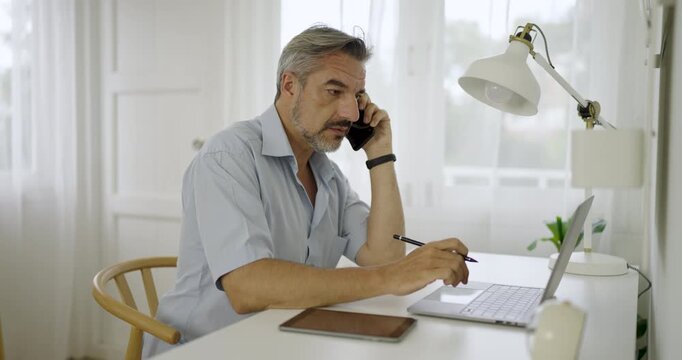 Portrait of happy caucasian business senior man casual cloths shirt work in home office desk using head phone computer. Small business employee freelance online sme marketing e-commerce telemarket