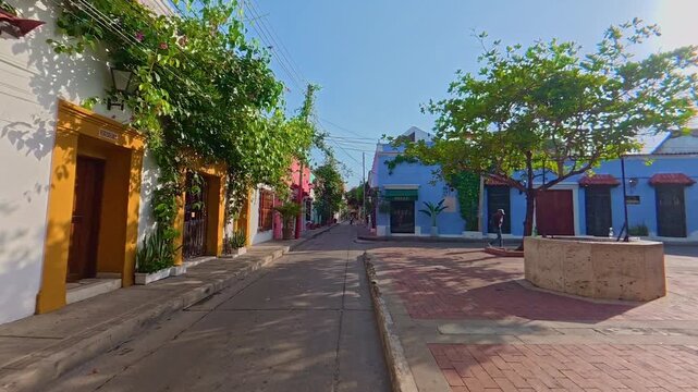 People walking on a colorful street in cartagena de indias, colombia