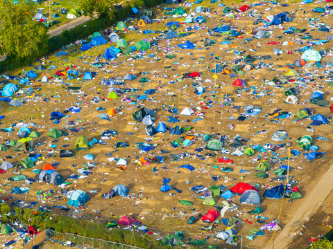 Reading, United Kingdom - 31 August 2026: Aerial view of Reading Festival campsite filled with numerous colorful tents and scattered litter on the grass after the music event.