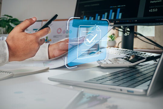 Business professional using smartphone to scan and verify paper document with digital OCR hologram interface, concept of document scanning, data extraction, paperless office, digital transformation.