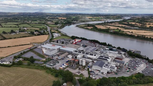 aerial pullback overview of meat processing plant Grannagh Kilkenny with Thomas Francis Meagher Bridge The River Suir and Waterford City in Background, busy plant serving the meat industry Ireland