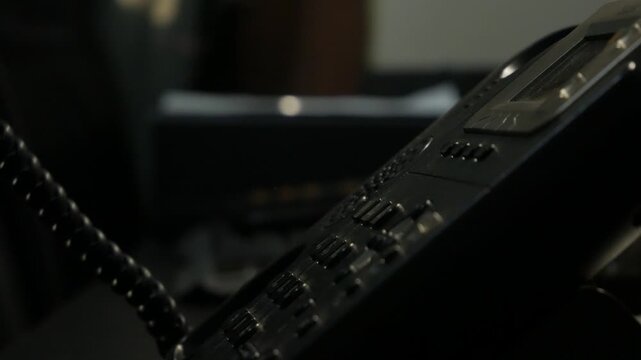 Close-Up Shot of Hand Picking Up Black Office Telephone Receiver