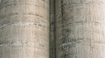 Naklejka premium Extreme close-up of industrial wheat grain storage elevators, minimalist architecture of concrete silos, details of agricultural infrastructure