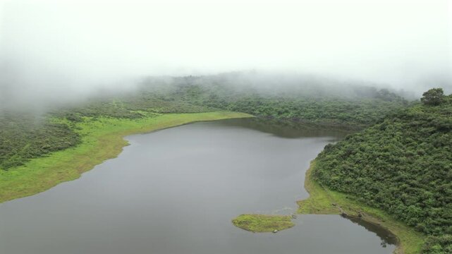 4K drone aerial view of Yala Provincial Park in Jujuy, Argentina. Misty mountain lakes surrounded by lush Yungas forests and dense green vegetation in a spectacular Andean landscape.
