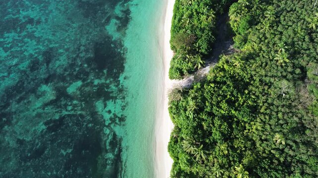 Drone pull back shot revealing a paradise sandbar and turquoise coral reef in Fiji islands