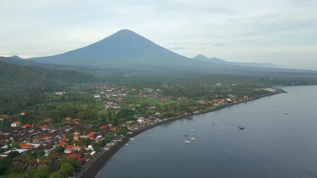 Mount Agung Early Morning Haze Drone Descend Over Volcanic Amed Beach Bali Indonesia 4K 60FPS
