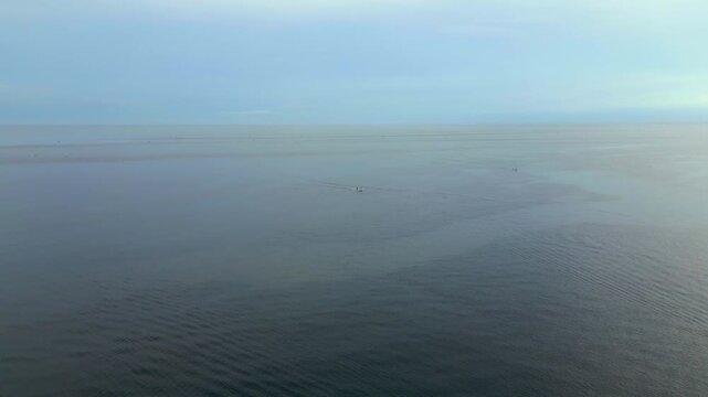 Lone Fishing Boat Tracks Across Empty Ocean Amed Bali Indonesia Morning 4K 60FPS