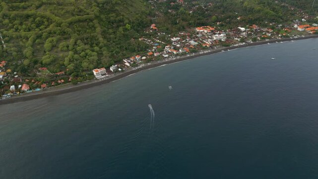 Fishing Boats Pull Into Amed Beach Village Black Sand Bali Indonesia Drone Overhead Shot 4K 60FPS
