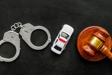 Crime concept. Police car toy, handcuff, judge hammer on black background top view copy space © 9dreamstudio