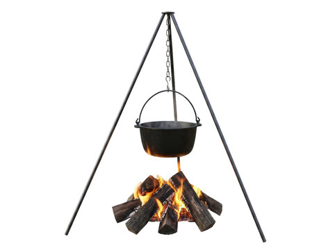 An outdoor campfire with a cast iron pot hanging from a tripod over burning logs.