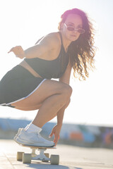 Skater practicing tricks on a board during sunny day at a skate park near the beach © KONSTANTIN SHISHKIN
