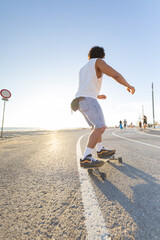 Skateboarding by the seaside during golden hour in a warm and sunny environment © KONSTANTIN SHISHKIN