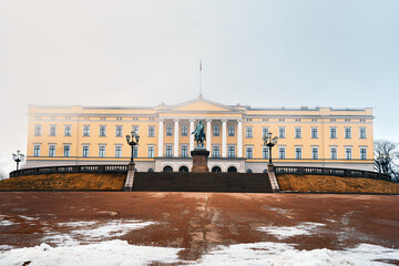 The neoclassical Royal Palace and equestrian statue above a snow-patched forecourt, Oslo © dachakrapan