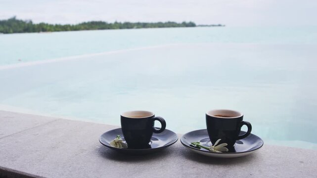 Luxury coffee travel experience. Coffee in espresso cups for two people on luxury pool side on vacation.