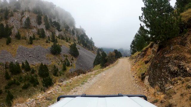 POV of an off-road vehicle driving down a mountain pass in the Sinjajevina region of Montenegro
