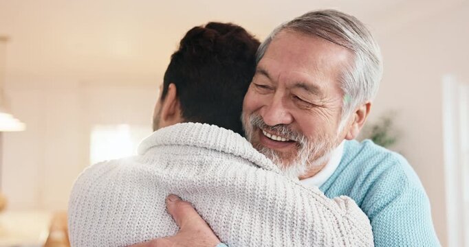 Hug, happy and man with senior father in home with bonding, connection or good news together. Smile, love and adult son embracing elderly dad in living room for support, trust or family in house.