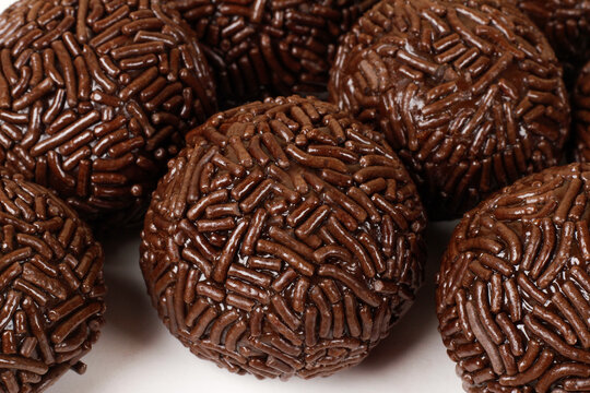 A serving of traditional Brazilian chocolate brigadeiros coated in sprinkles. A popular treat at parties and celebrations.