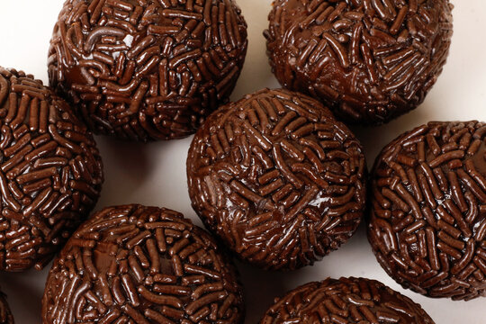 A serving of traditional Brazilian chocolate brigadeiros coated in sprinkles. A popular treat at parties and celebrations.