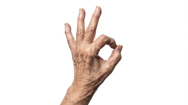 Closeup of an elderly persons hand making an okay gesture isolated on white background world kindness day
