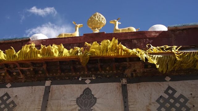 Gilded dharmachakra wheel and twin deer roof ornament on a monastery, Lo Manthang, Upper Mustang, Nepal