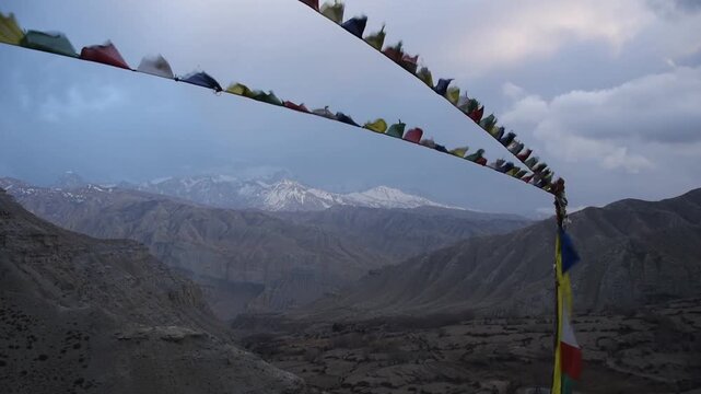 Prayer flags framing the snow-capped peaks of the Annapurna range, Ghiling Gompa, Upper Mustang, Nepal