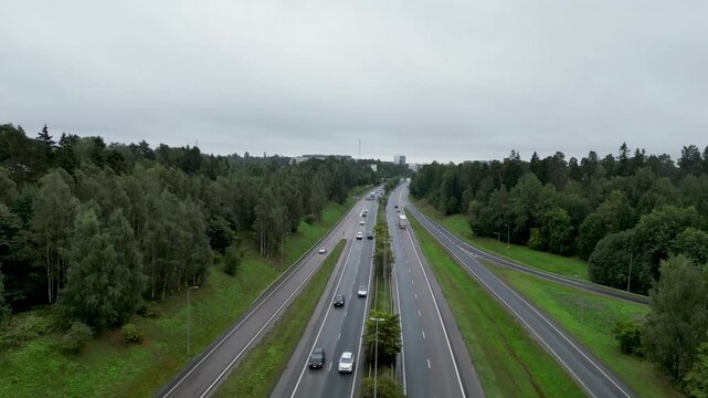 Aerial drone video of K&auml;skynhaltijantie and the surrounding urban landscape between Maunula and K&auml;pyl&auml; in Helsinki, Finland. Residential buildings, streets, green areas, and the Nordic cityscape captu