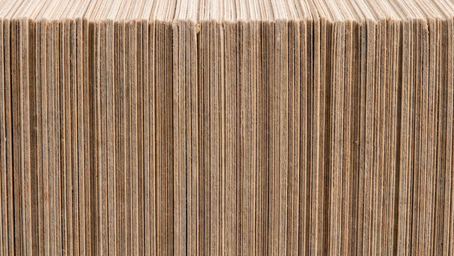 Close up macro texture of a thick stack of stacked brown kraft paper sheets
