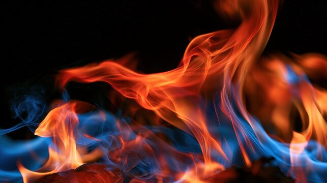 Macro photograph of fiery tongues and smoke on a solid black surface