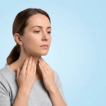 Woman Touching Her Throat Concerned About Health Symptoms