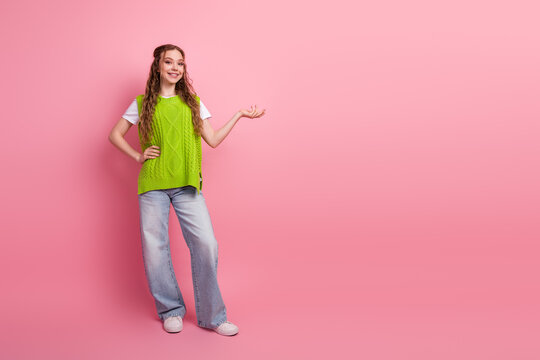 Happy young girl posing in bright lime vest against pink background for fashion lifestyle stock image
