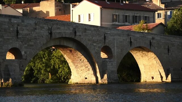 Golden light on the arches of the Pont Vieux crossing the Orb, Beziers, Herault, Occitanie, France