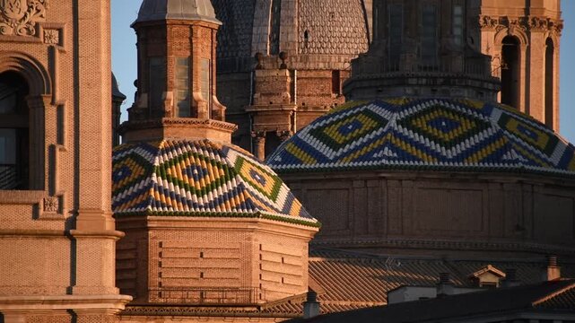 Polychrome tiled cupolas of the Basilica del Pilar in diamond pattern, Zaragoza, Aragon, Spain, in warm raking light