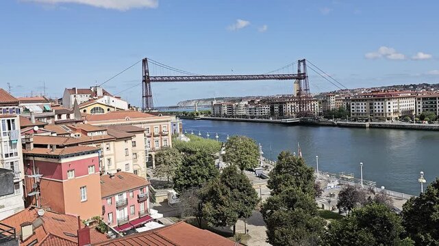 The Vizcaya Bridge spans the estuary above old-town rooftops, Portugalete, Biscay, Spain