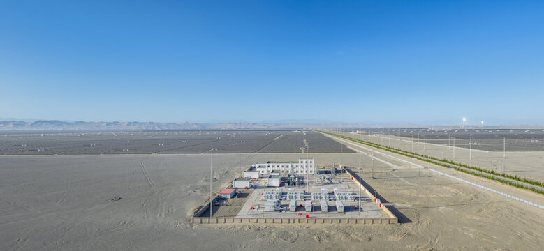 Aerial View of Energy Storage Station and Vast Solar Farm in Dunhuang Desert Landscape